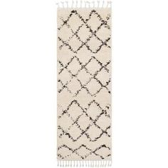 a white and black rug with tassels on the bottom, in front of a white background