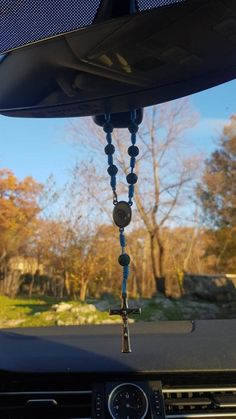 a car dashboard with beads hanging from it's dash board