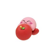 a pink toy with a red tomato on it's nose