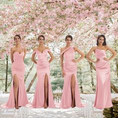 four women in pink dresses standing next to each other with their hands on their hips