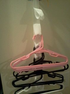 a pink and black hanger is hanging on the wall