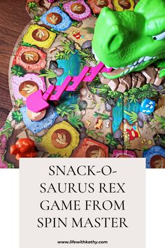 a close up of a game on a table with the title snack - o saurrus rex game from spin master