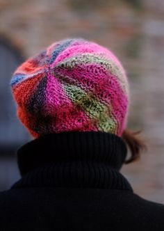 a person wearing a multicolored knitted hat