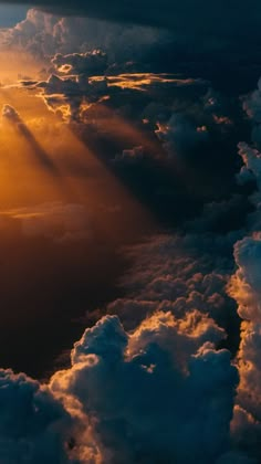 the sun shines through clouds as seen from an airplane