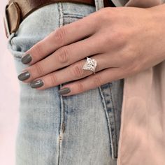 a woman's hand with a ring on her finger