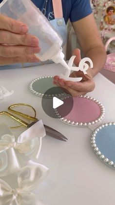 a person is making decorative items on a table