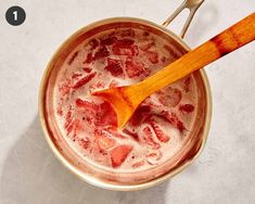 a wooden spoon in a bowl filled with liquid