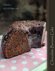 a piece of chocolate cake sitting on top of a pink napkin