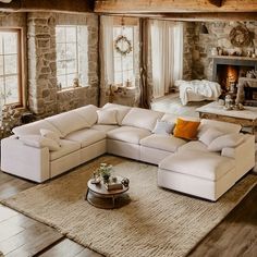 a living room filled with furniture and a fire place in the middle of an open floor plan