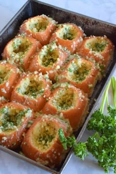 a pan filled with lots of food on top of a table