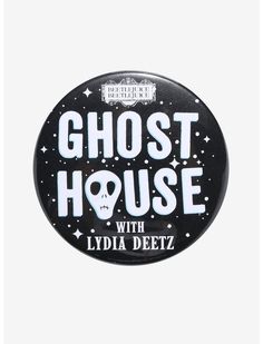 a black and white button with the words ghost house on it's front side