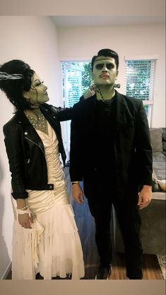 two people dressed in costumes standing next to each other