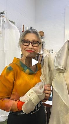 an older woman is showing off her new dress in front of a mannequin