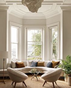 a living room filled with furniture and windows