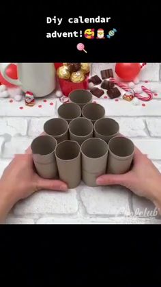 someone is holding up some cups in their hands