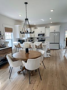 a dining room table with chairs around it in the middle of a large open floor plan