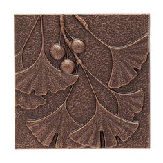 an art deco tile design with leaves and berries on it, in bronze brown tones