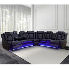 a living room filled with black leather couches and recliners on top of a rug