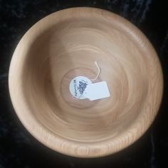 a wooden bowl with a white tag in it