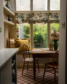 a kitchen with a table and chairs in it