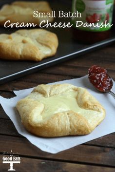 small batch cream cheese danish on a piece of parchment paper with jam in the background