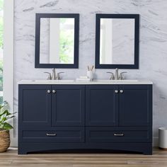 a bathroom with two sinks and mirrors on the wall