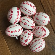 red and white painted eggs on a wooden table