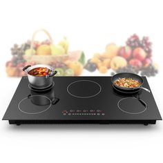 an electric cooktop with two pans on the burners and food in front of it