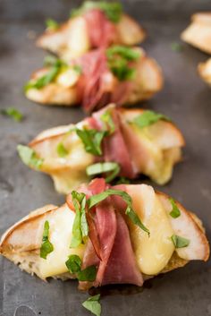 small appetizers are lined up on a baking sheet