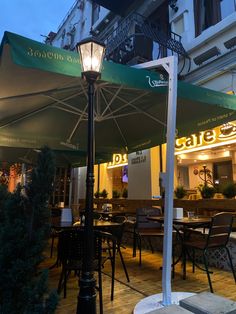 an outdoor dining area with tables and umbrellas