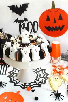 a halloween cake decorated with white chocolate and spooky ghost decorations on a table