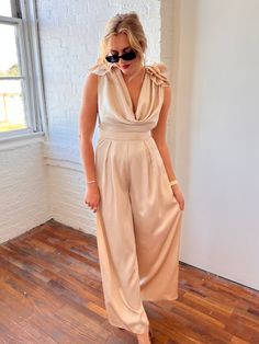 champagne colored jumpsuit deep cowl neckline in front & back 3D floral applique on shoulders pleated wide leg pant side zipper closure Jumpsuit Cocktail Outfit, Cocktail Chic Outfit, Wedding Jumpsuit Bridesmaid, Champagne Jumpsuit, Bridesmaid Jumpsuit, Garden Cocktail, Bride Jumpsuit, Bridesmaids Jumpsuits, Cocktail Chic