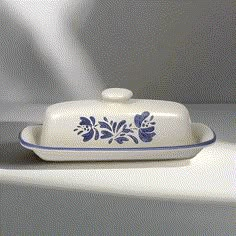 a blue and white serving dish sitting on top of a counter next to a wall