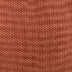 an orange cloth textured with some sort of woven material, closeup or background