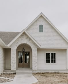 a white house with a gray front door