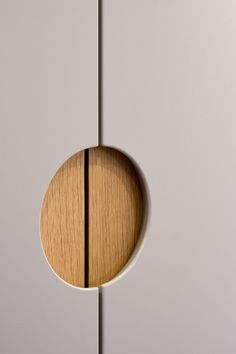 a wooden object is hanging on the wall