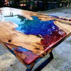 a wooden table with blue and red paint on it