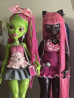 two monster dolls standing next to each other