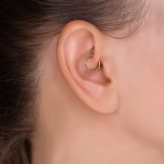 a close up of a person's ear with a ring on the middle of it