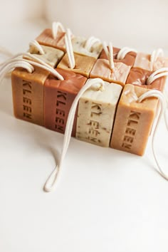 four soap bars tied together with string on white surface