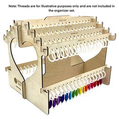 the wooden rack holds several different colored crochet hooks and is attached to it