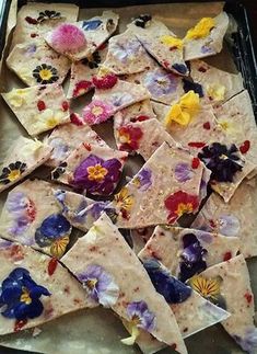 a pan filled with tortilla chips covered in edible flowers