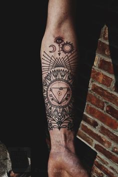 a man's arm with a tattoo on it and an eye in the center