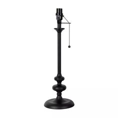 a tall black metal pole with a clock on it's face and chain hanging from the top