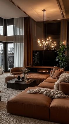 a living room filled with lots of furniture next to a large glass window covered in curtains