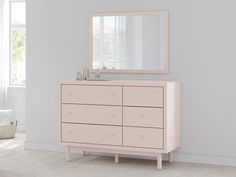 a pink dresser and mirror in a white room with light colored walls, flooring and windows