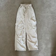 Never Worn - Size: M Beige Utility Parachute Pants For Fall, Beige Cargo Style Parachute Pants For Fall, Fall Utility Beige Parachute Pants, Trendy Beige Cargo Pants For Spring, Casual Neutral Pants With Side Pockets, Trendy Baggy Beige Cargo Pants, Trendy Summer Beige Cargo Pants, Fall Cream Cargo Pants With Pockets, Trendy Beige Bottoms For Streetwear