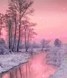 a pink sky over a river with trees in the foreground and snow on the ground