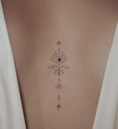 a woman's chest with an all seeing eye tattoo on it