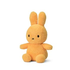 a yellow stuffed rabbit sitting in front of a white background